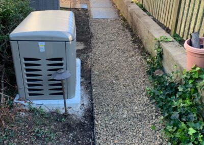 A small generator placed in a yard, providing power.