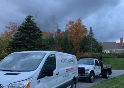 Two white vans parked on the side of the road, ready for their next journey.