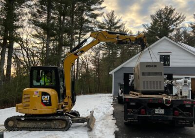 A yellow excavator parked in the snow, ready for action